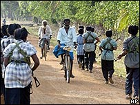 Female Tamil Tigers pass civilians in rebel-held territory