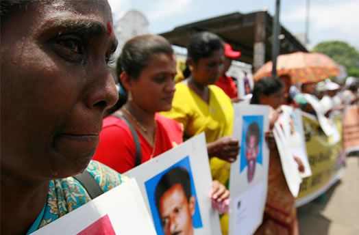 A demonstrator cries while holding a picture of her relative who went missing during Sri Lanka's war with the Liberation Tigers of Tamil Eelam (LTTE) as she takes part in a protest in Colombo September 9, 2009. Photo: Andrew Caballero-Reynolds/Reuters