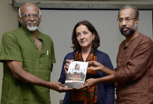 Poet Cheran (right) handing over the first copy of the Tamil version of Frances Harrison’s book to art critic Sadanand Menon (left) at a function in Chennai on Saturday. Photo: R.Ravindran