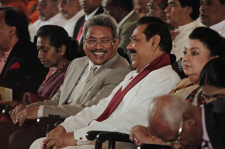 BROTHERLY LOVE: President Mahinda Rajapaksa (in white and wearing a scarf) rules the country with his son and two brothers, including Defense Secretary Gotabhaya Rajapaksa (to his right), and assorted members of the Rajapaksa clan. 