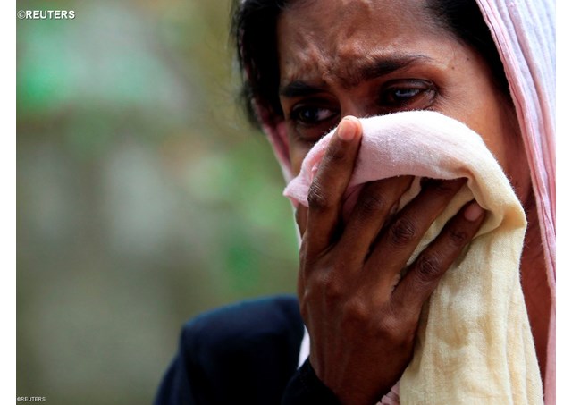 A Muslim woman weeping next to her house burnt by Buddhists in Aluthgama, June 16, 2014. - REUTERS