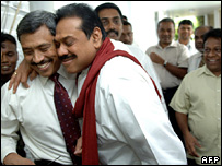 Sri Lanka's president (r) hugs his brother who has just escaped a suicide attack