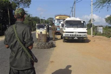 Soldier letting white van through checkpoint in Sri Lanka