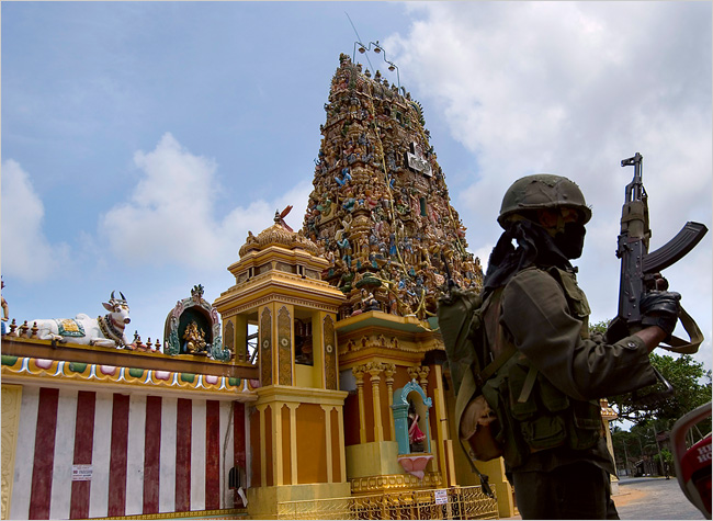 A Sri Lankan Army soldier blocked civilian traffic to clear a road for troop movements past the Nachchi Amman Temple in Jaffna, a key flashpoint in the recently-escalating conflict between the government and Tamil rebels. June 15, 2007
