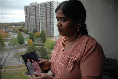 Malini Thambipillai holds a photo of her husband, Sritharan Subramaniam, who went missing a month ago in Sri Lanka. Oct 2008