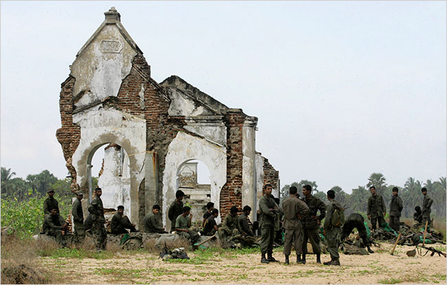 Sri Lankan troops on January 27 2009 at the ruins of a church in Mullaittivu, the last major town that had been held by the Tamil Tigers.	