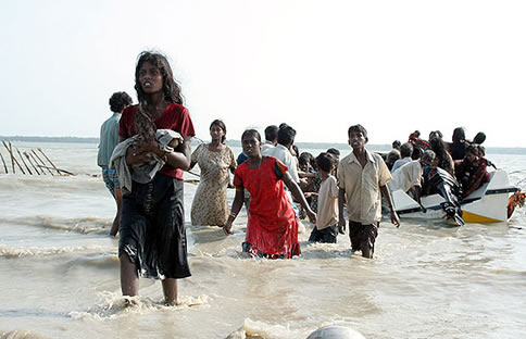 This photograph released by the Sri Lankan military May 15, 2009 shows what the army say are civilians wading and using boats to cross a lagoon to escape the island's war zone, where the military has surrounded Tamil Tiger rebels for the final battle in a quarter-century conflict.