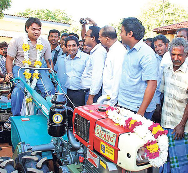 Nimal Rajapaks presenting plow to war-affected Sinhalese farmers ~2010
