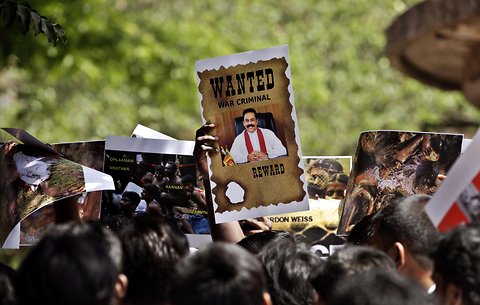 An Indian Tamil holds a portrait of Sri Lankan President Mahinda Rajapaksa during a protest in Mumbai, Maharashtra. They were protesting against the alleged war crimes committed by the Sri Lankan government’s forces during the civil war that ended in 2009.