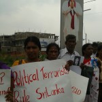 Families hold up placards in protest in Jaffna during UK PM's visit