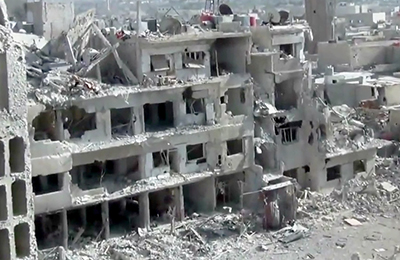 An image taken by the Shaam News Network, a Damascus-based citizen news organization, shows buildings damaged by heavy shelling. (AP/Shaam News Network)