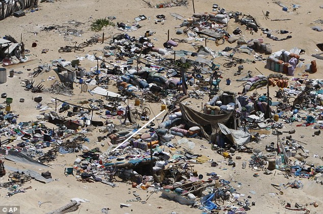  Daily Mail May 25 2009 Civilians' belongings are scattered about the ground after the attacks