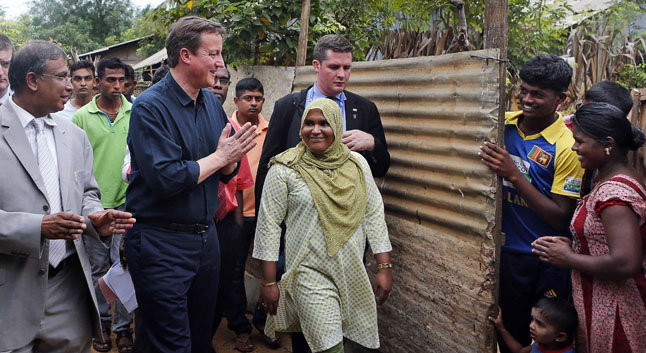 British Prime Minister David Cameron greets villagers of Internally displaced people's camp at Chunnakam village, in Jaffna, northern Sri Lanka, during his visit in 2013. Pic: AP.